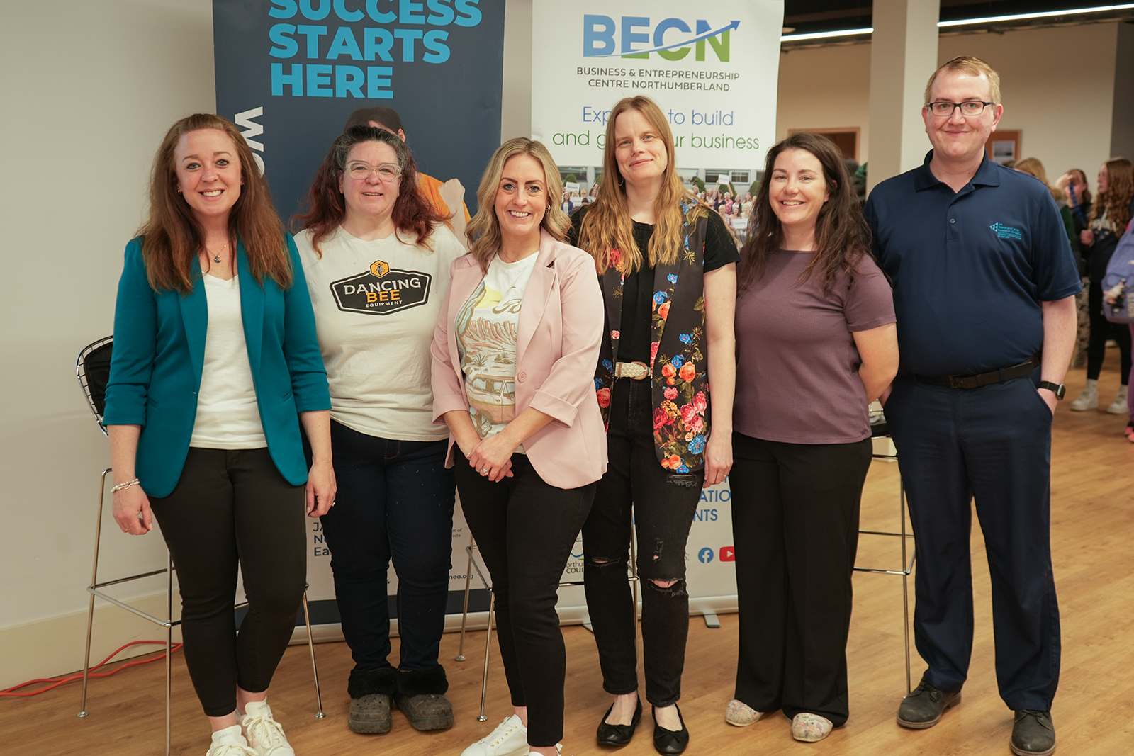Group of people standing together at FemSTEAM event indoors