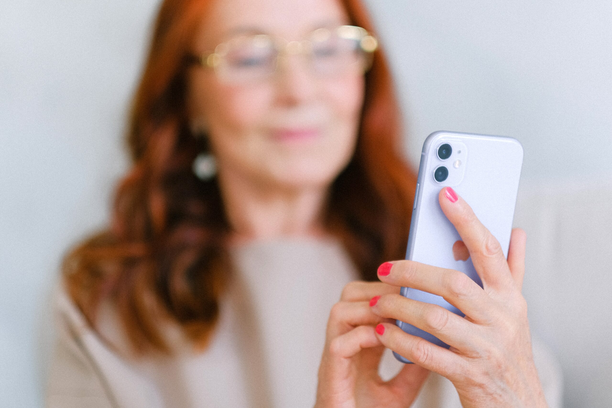 Woman looks at iphone